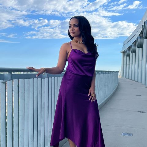 Kyla Pratt is in a purple dress.